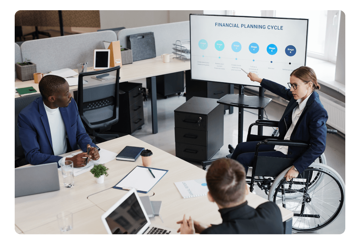 3 people, one of them, the one in a wheelchair, making a speech with a pitch.