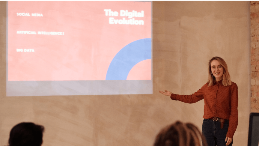 Photograph of 1 young girl presenting a thesis with a projected interactive presentation