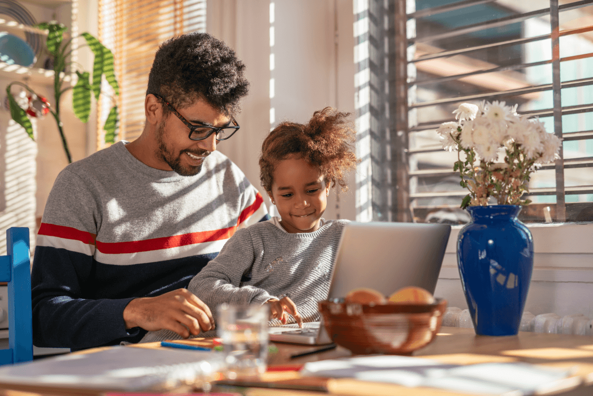 Father working from home alongside his daughter
