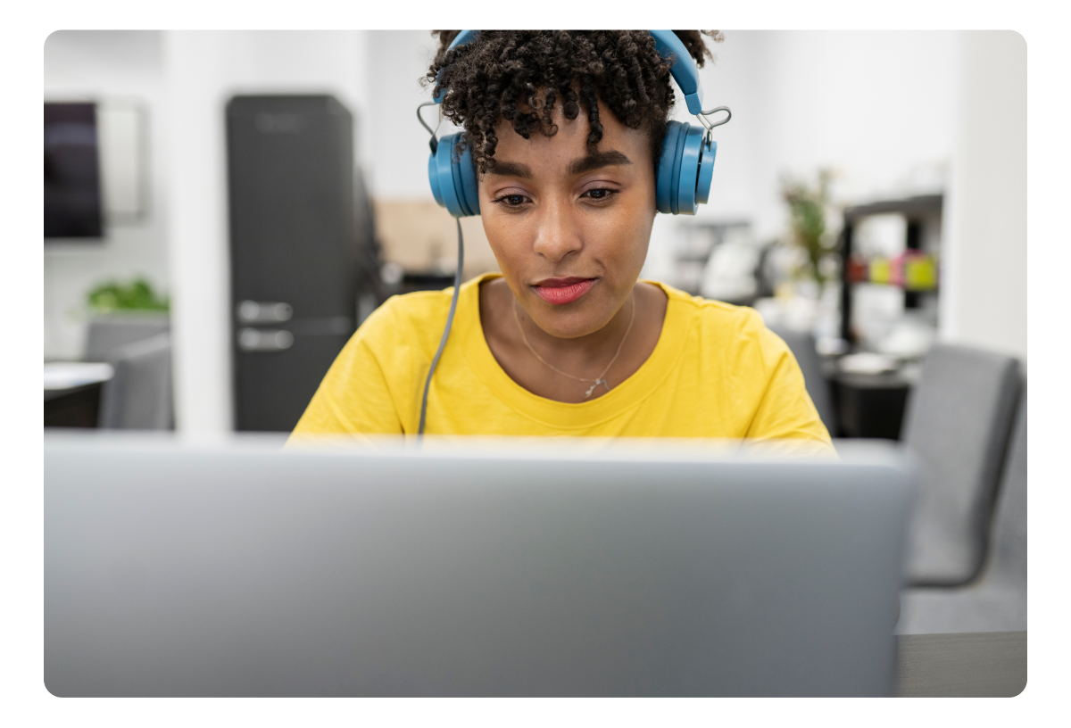 A black girl with headphone and a laptop