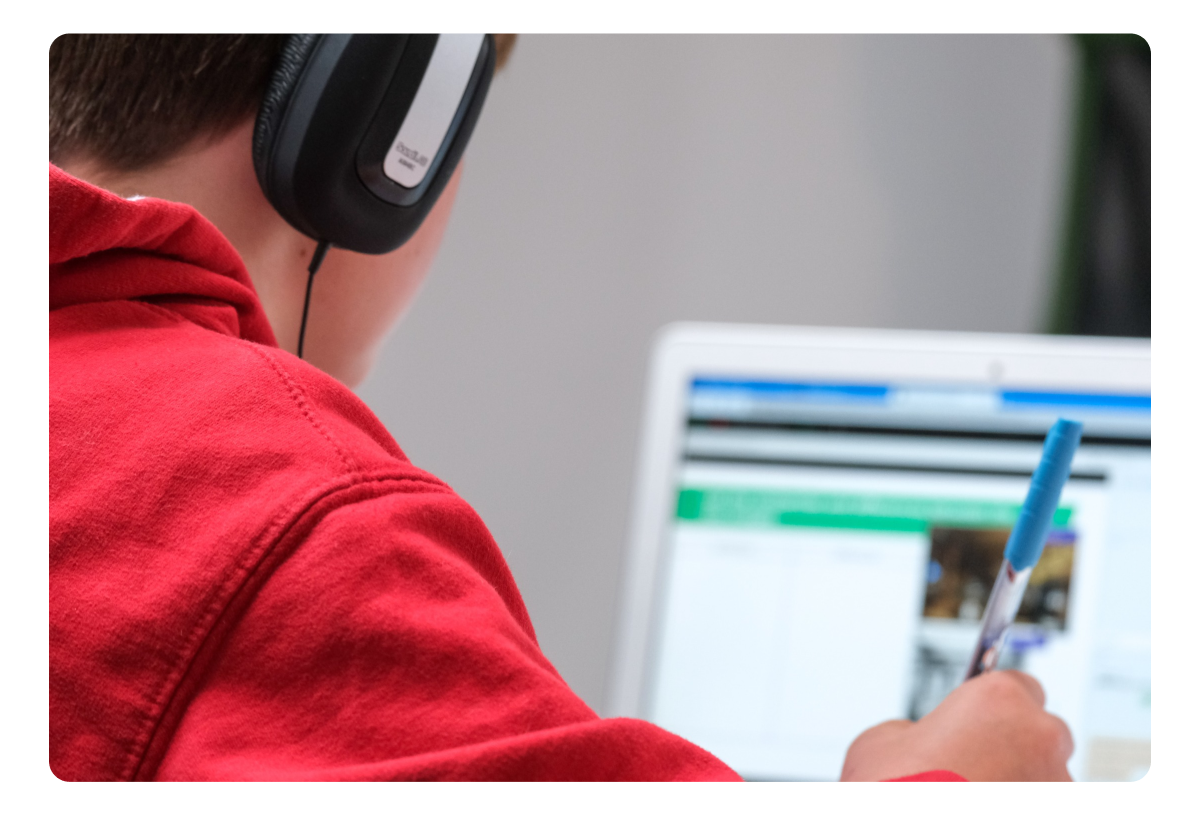Photograph of a child studying with a laptop